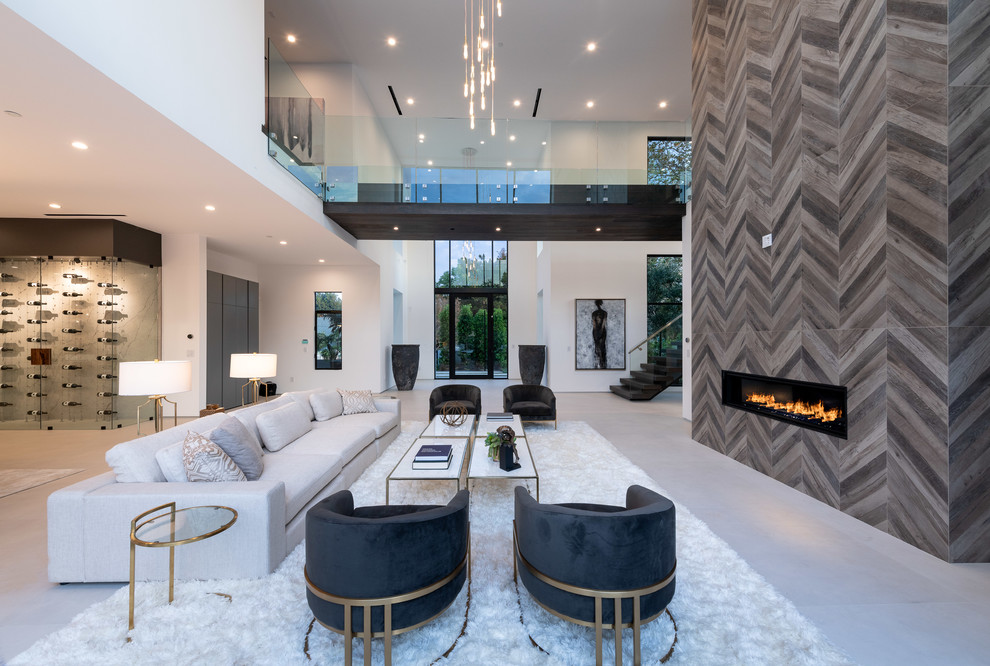This is an example of a contemporary formal open concept living room in Los Angeles with a ribbon fireplace, a tile fireplace surround and white floor.