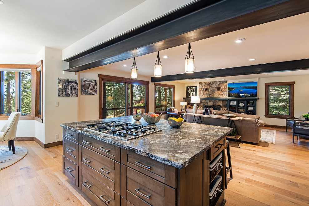Inspiration for a large rustic light wood floor eat-in kitchen remodel with an undermount sink, shaker cabinets, granite countertops, gray backsplash, ceramic backsplash, stainless steel appliances and an island