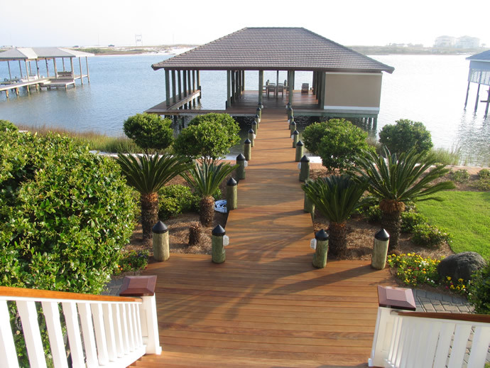 This is an example of a mid-sized traditional backyard deck in Miami with with dock and a pergola.