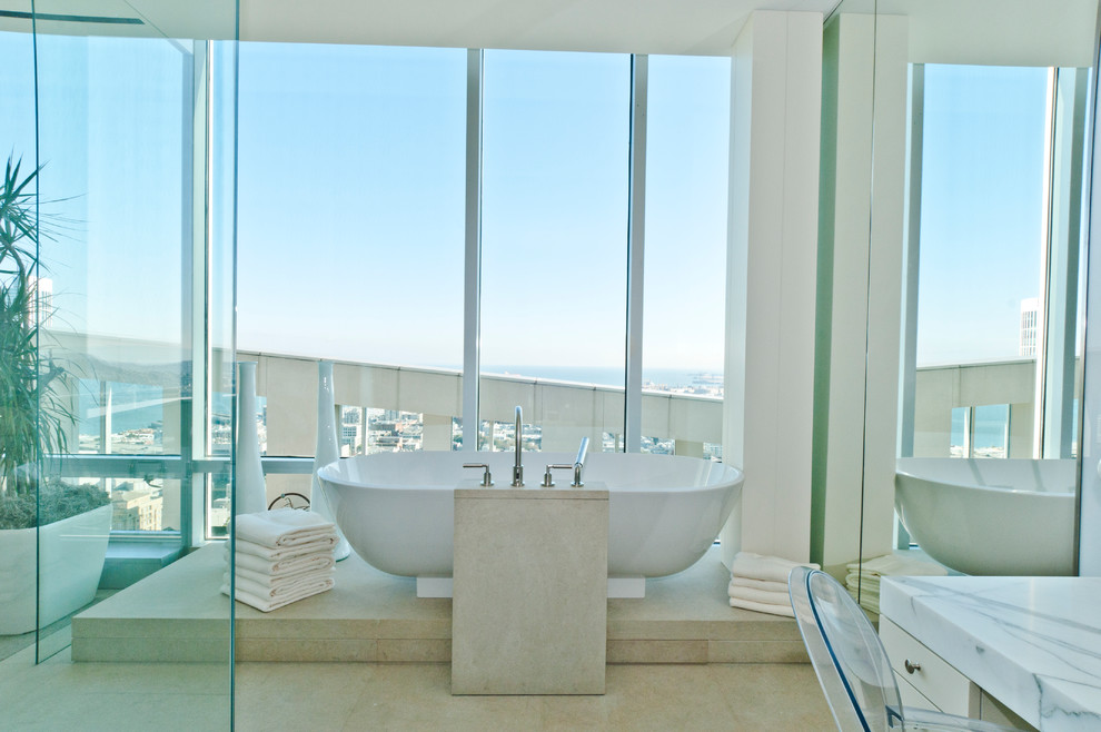 Contemporary bathroom in San Francisco with a freestanding tub and marble benchtops.