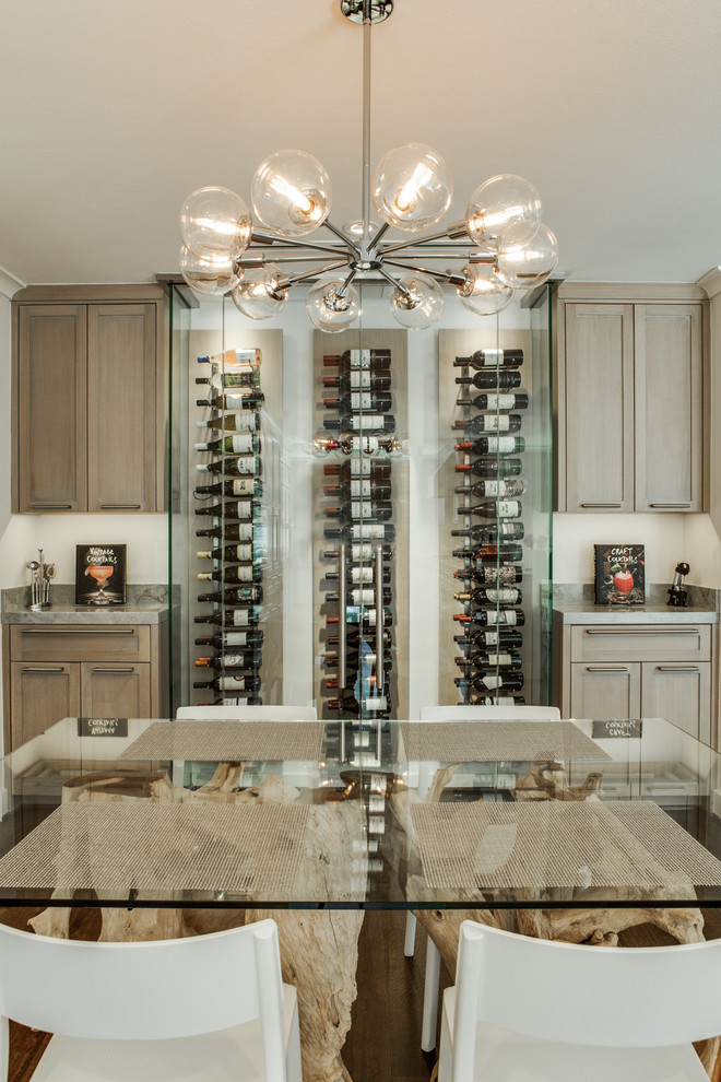 Design ideas for a mid-sized midcentury wine cellar in Dallas with medium hardwood floors and display racks.