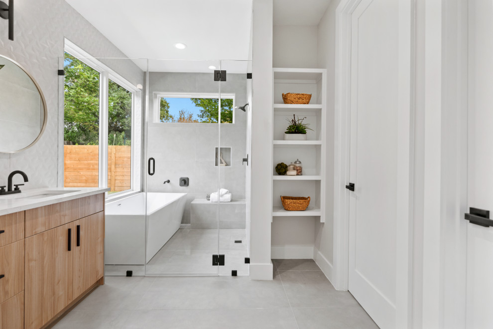Inredning av ett lantligt vit vitt en-suite badrum, med släta luckor, ett fristående badkar, våtrum, vit kakel, vita väggar, ett undermonterad handfat, grått golv och dusch med gångjärnsdörr