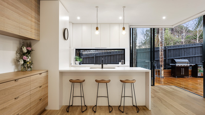 Contemporary kitchen in Melbourne with concrete benchtops.