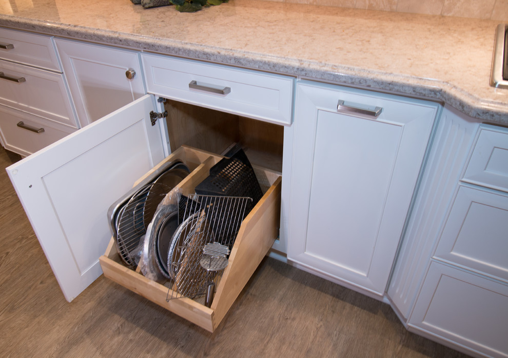 Inspiration for a huge transitional open concept kitchen remodel with a farmhouse sink, recessed-panel cabinets, white cabinets, quartz countertops, beige backsplash, stone tile backsplash, stainless steel appliances and an island