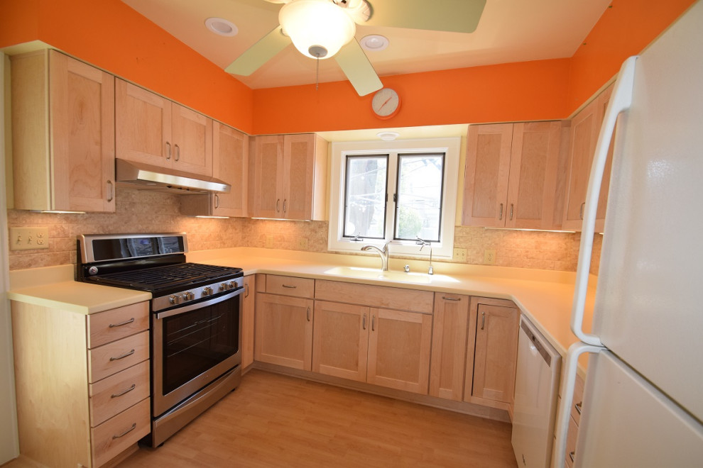 Inspiration for a mid-sized transitional u-shaped light wood floor kitchen remodel with an integrated sink, shaker cabinets, light wood cabinets, multicolored backsplash, stone tile backsplash, a peninsula and white countertops