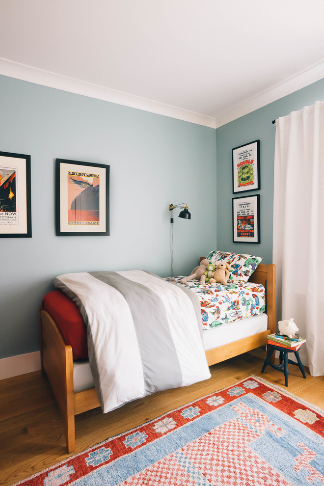 Mid-sized transitional kids' bedroom in Other with blue walls, light hardwood floors and brown floor for kids 4-10 years old and boys.