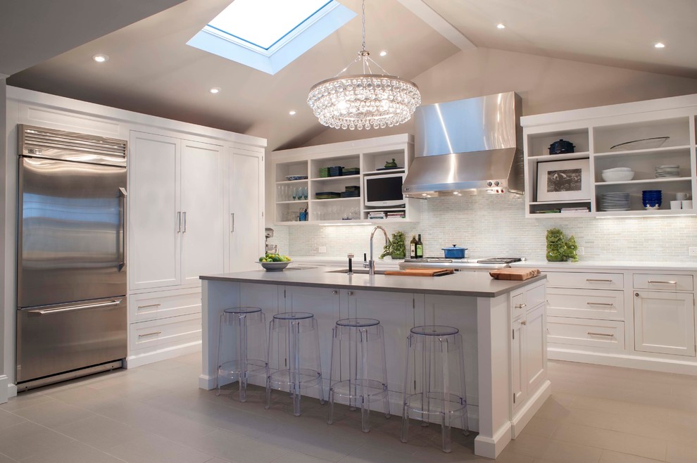 Eat-in kitchen - large coastal u-shaped ceramic tile eat-in kitchen idea with an undermount sink, shaker cabinets, white cabinets, quartz countertops, white backsplash, stainless steel appliances, gray walls and an island
