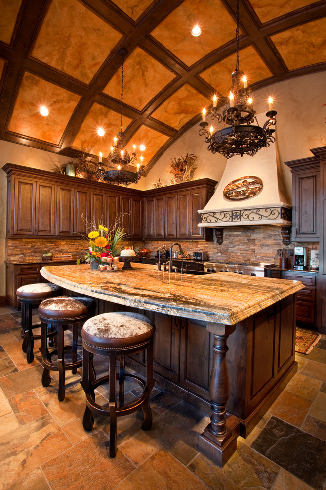 Inspiration for a large country u-shaped open plan kitchen in Dallas with a farmhouse sink, raised-panel cabinets, dark wood cabinets, marble benchtops, beige splashback, stone tile splashback, stainless steel appliances, slate floors and with island.