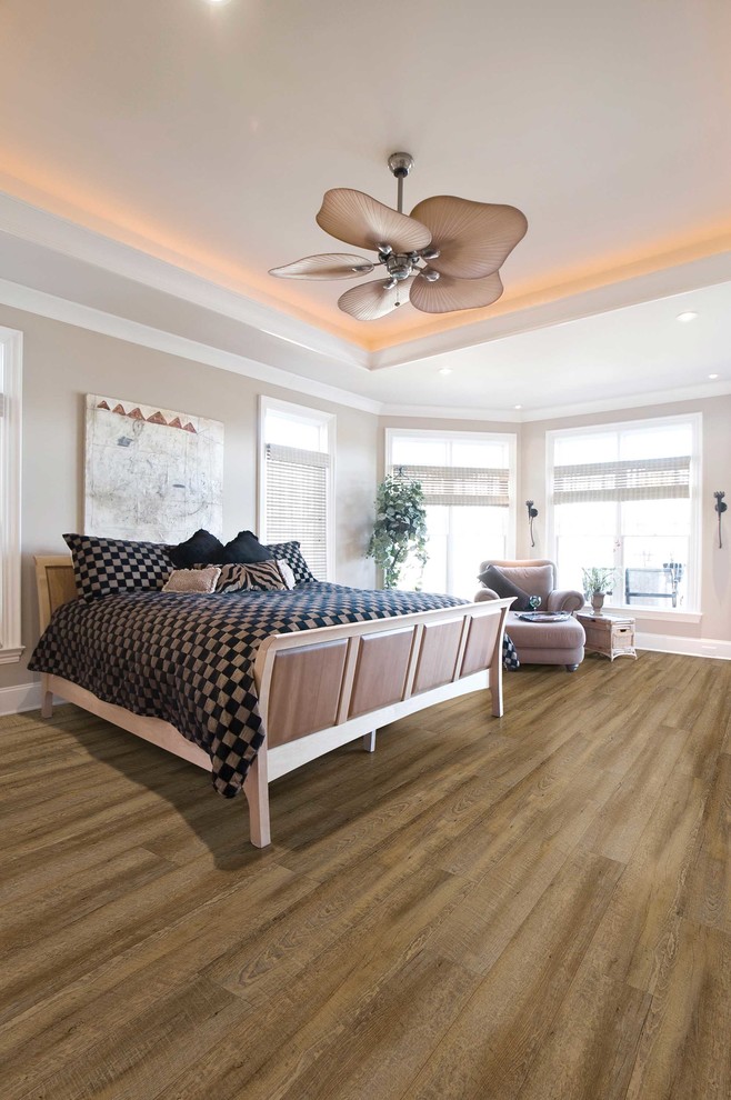 Inspiration for a mid-sized contemporary master bedroom in Nashville with beige walls, medium hardwood floors and brown floor.