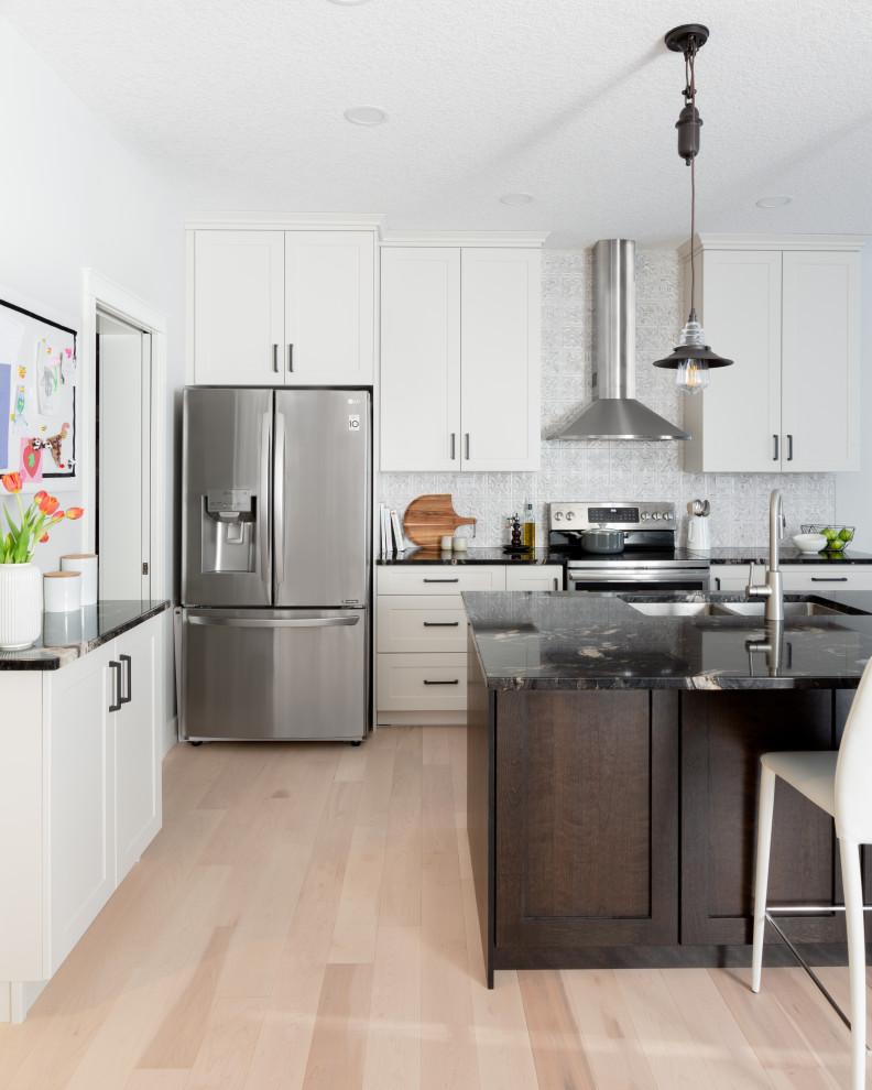 Example of a transitional kitchen design in Calgary