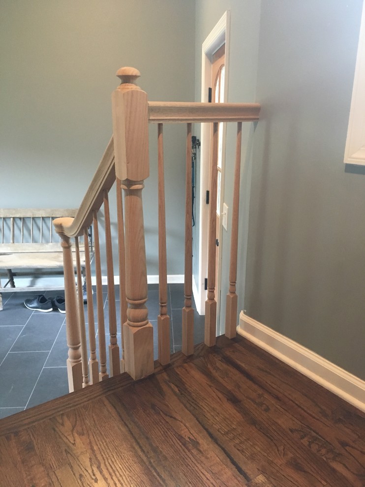 This is an example of a small traditional wood straight staircase in New York with wood risers and wood railing.