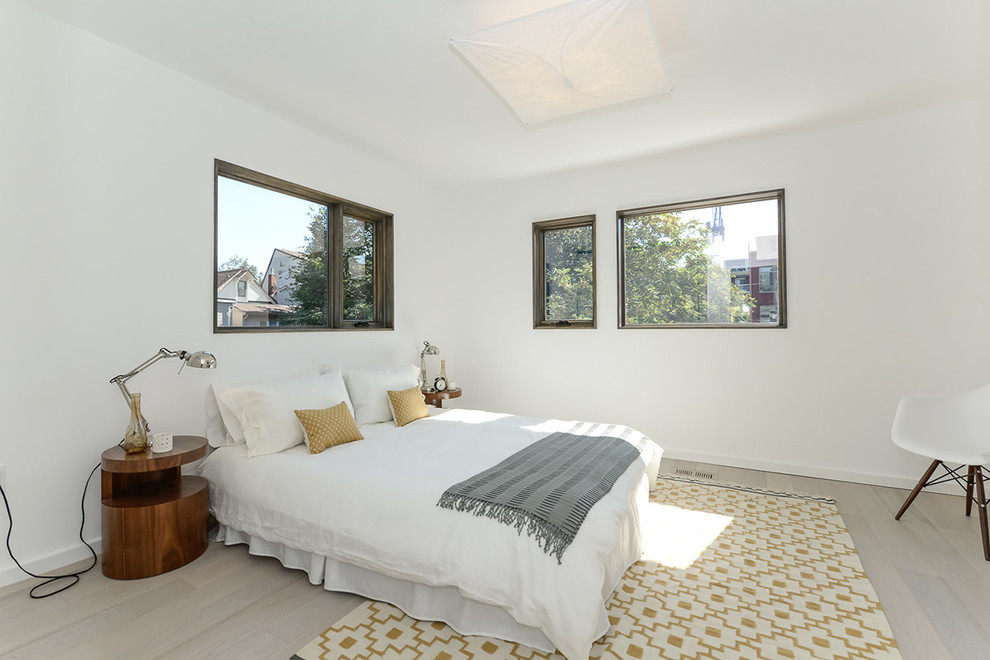 Mid-sized contemporary master bedroom in Toronto with white walls and light hardwood floors.