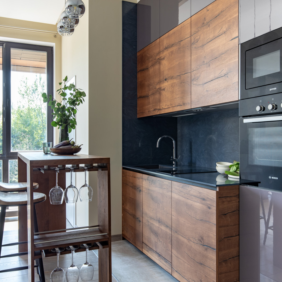 Mid-sized single-wall eat-in kitchen in Moscow with a single-bowl sink, grey cabinets, solid surface benchtops, blue splashback, panelled appliances and blue benchtop.