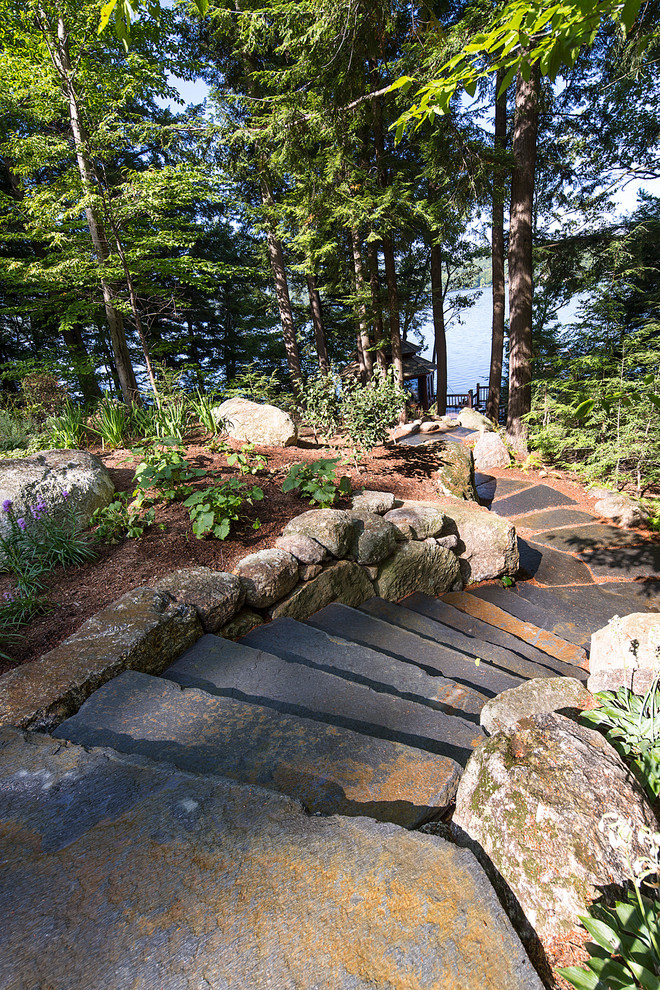 Design ideas for a mid-sized contemporary backyard partial sun garden in Burlington with natural stone pavers.