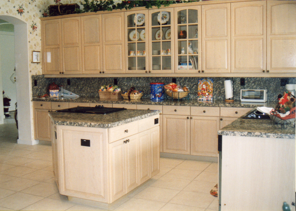 Photo of a large traditional l-shaped separate kitchen in Miami with a double-bowl sink, glass-front cabinets, light wood cabinets, marble benchtops, multi-coloured splashback, porcelain splashback, black appliances, ceramic floors and with island.