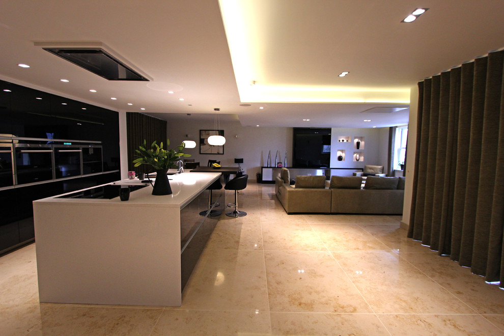 Inspiration for a large contemporary single-wall eat-in kitchen in Manchester with marble floors and with island.