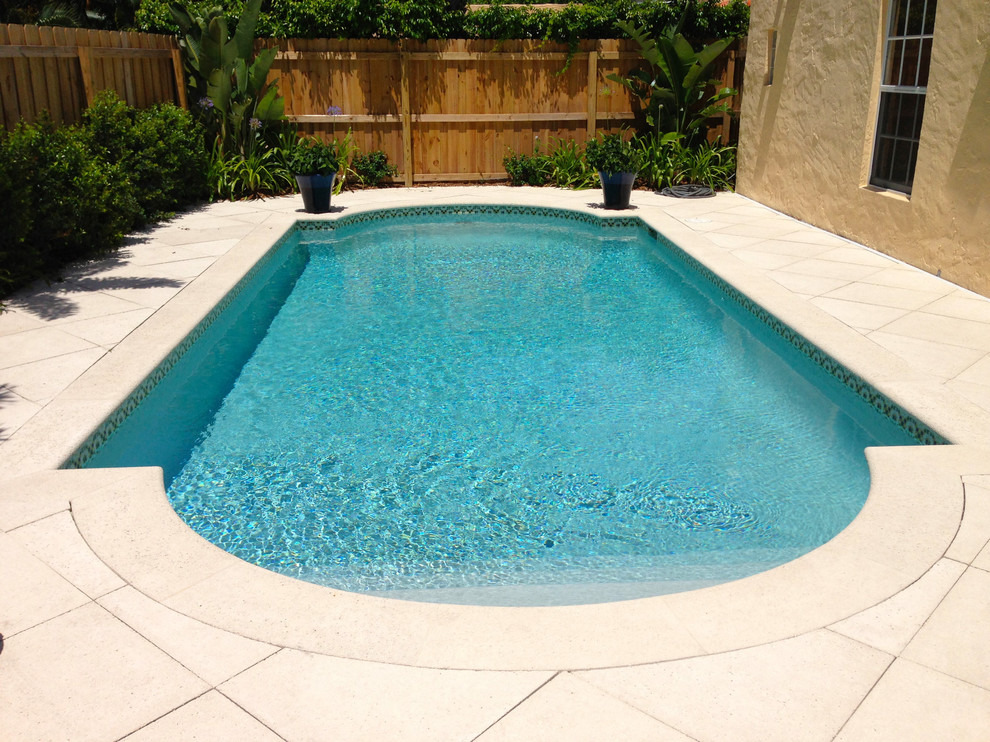 Inspiration for a large contemporary backyard rectangular lap pool in Miami.