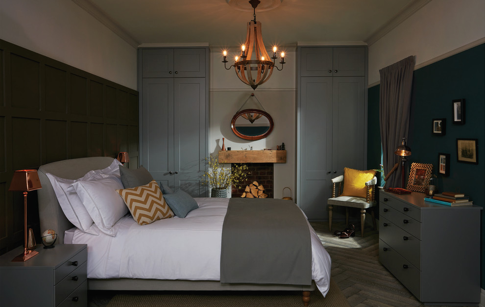 Design ideas for a mid-sized contemporary master bedroom in Cambridgeshire with grey walls, painted wood floors, no fireplace and a stone fireplace surround.