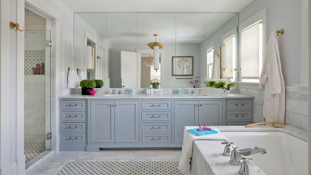 Inspiration for an eclectic master bathroom in Minneapolis with flat-panel cabinets, blue cabinets, an undermount tub, an alcove shower, gray tile, marble, grey walls, mosaic tile floors, an undermount sink, marble benchtops, grey floor, a hinged shower door and white benchtops.