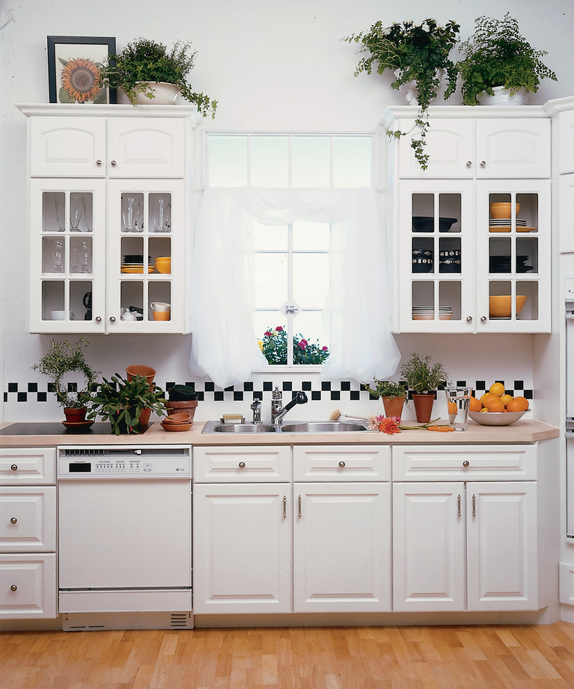 Design ideas for a mid-sized country u-shaped kitchen pantry in Detroit with a drop-in sink, raised-panel cabinets, white cabinets, laminate benchtops, multi-coloured splashback, subway tile splashback, white appliances, light hardwood floors and no island.