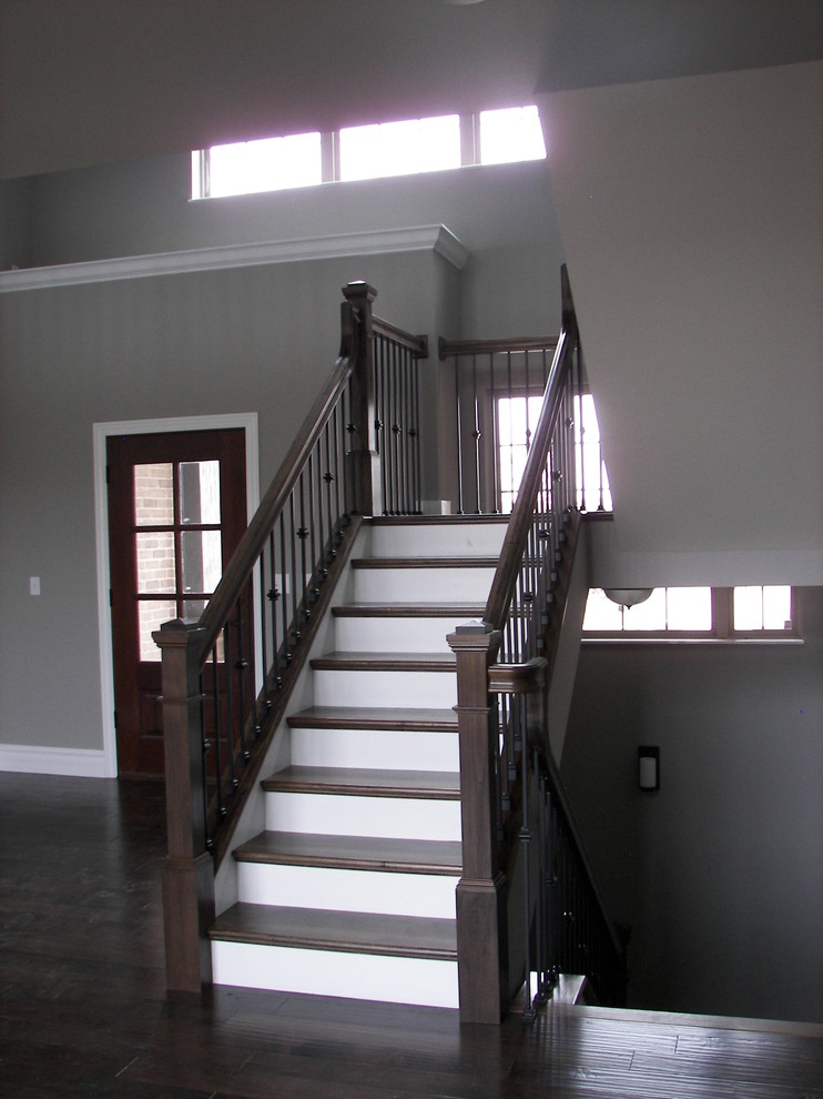 Inspiration for a mid-sized contemporary wood u-shaped staircase in St Louis with painted wood risers.