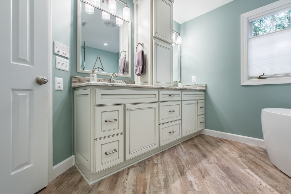 Design ideas for a large transitional master bathroom in DC Metro with beaded inset cabinets, white cabinets, a freestanding tub, a corner shower, a two-piece toilet, brown tile, porcelain tile, blue walls, porcelain floors, an undermount sink, granite benchtops, multi-coloured floor and an open shower.