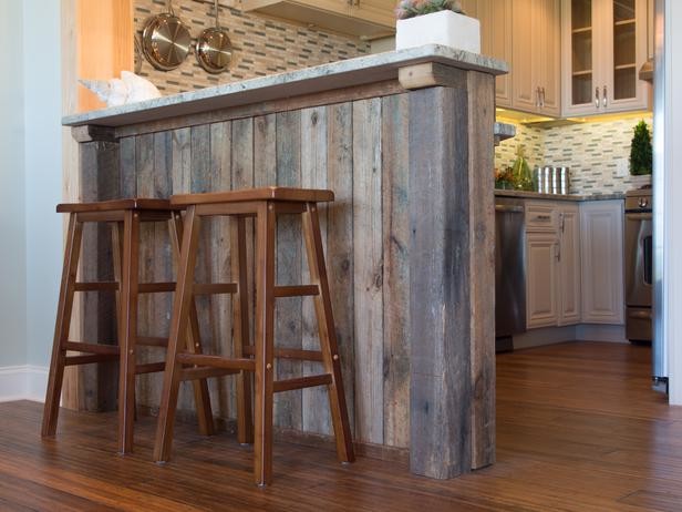 Inspiration for a small rustic galley medium tone wood floor eat-in kitchen remodel in Raleigh with raised-panel cabinets, beige cabinets, granite countertops, multicolored backsplash, matchstick tile backsplash, stainless steel appliances and a peninsula