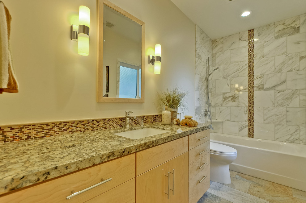 This is an example of a large midcentury master bathroom in San Francisco with flat-panel cabinets, light wood cabinets, an undermount tub, a curbless shower, a one-piece toilet, white tile, marble, beige walls, slate floors, an undermount sink, granite benchtops, beige floor and an open shower.