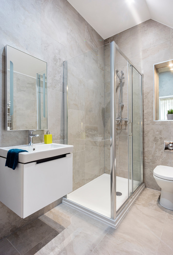 Transitional bathroom in Dorset with a wall-mount sink, a corner shower and a one-piece toilet.