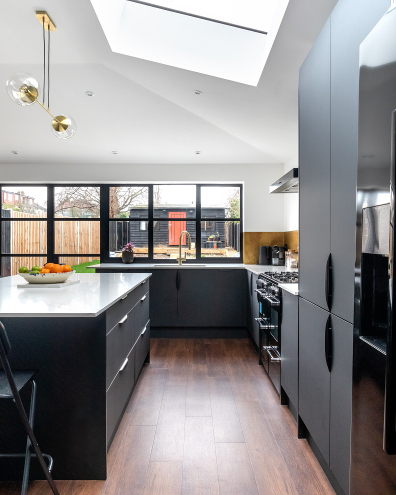 Design ideas for a contemporary open plan kitchen in London with a peninsula.