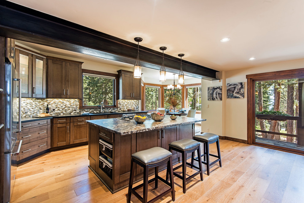 Large mountain style light wood floor and beige floor eat-in kitchen photo with shaker cabinets, granite countertops, an island, dark wood cabinets, multicolored backsplash and mosaic tile backsplash