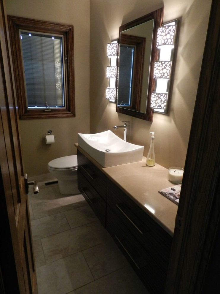 Bathroom - mid-sized transitional 3/4 bathroom idea with a two-piece toilet, brown walls, a vessel sink and beige countertops