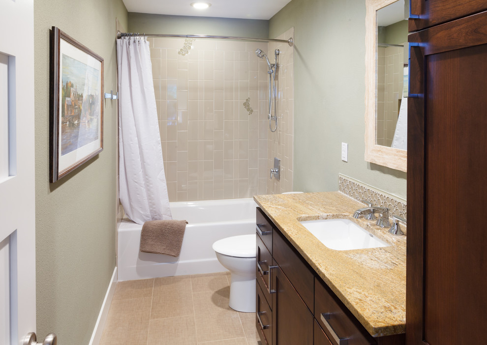 Inspiration for a mid-sized traditional kids bathroom in Portland with shaker cabinets, dark wood cabinets, an alcove tub, a shower/bathtub combo, a two-piece toilet, beige walls, ceramic floors, an undermount sink, granite benchtops, beige floor, a shower curtain and orange benchtops.