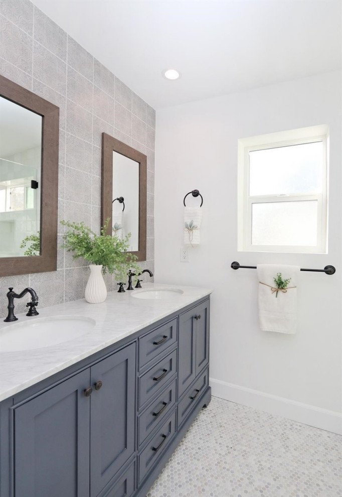Example of a tuscan gray tile and glass sheet mosaic tile floor, white floor and double-sink alcove shower design in Los Angeles with beaded inset cabinets, blue cabinets, a one-piece toilet, white walls, an undermount sink, quartz countertops, a hinged shower door, white countertops, a niche and a built-in vanity