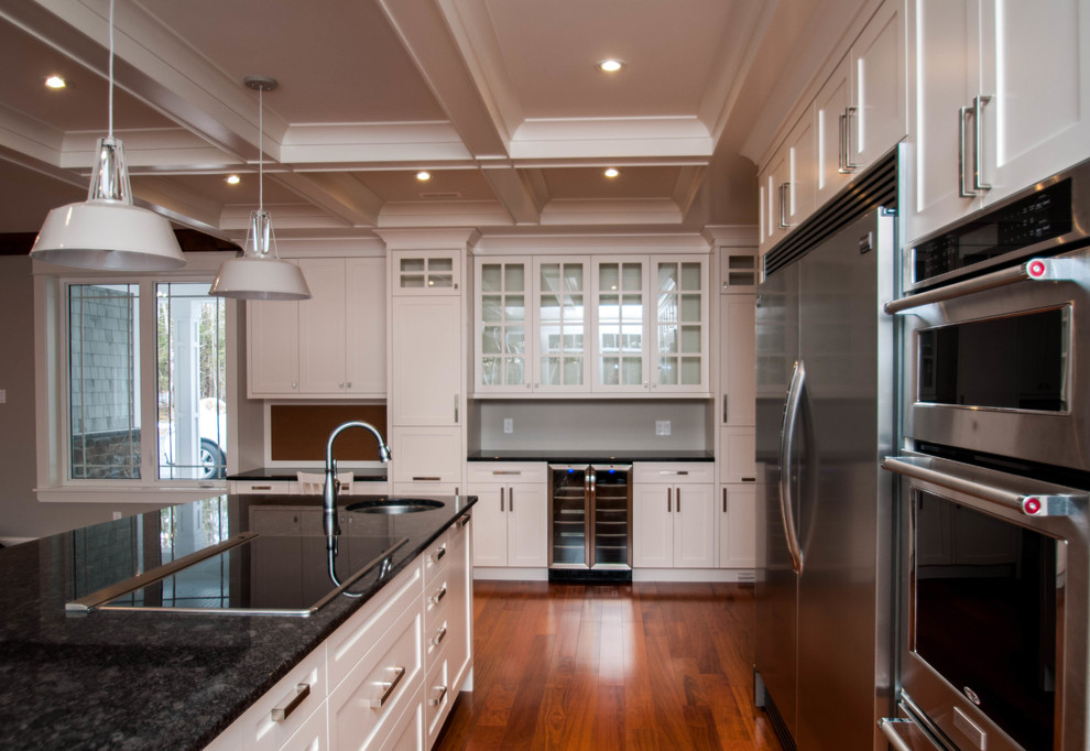 Inspiration for a transitional dark wood floor kitchen remodel with a farmhouse sink, shaker cabinets, white cabinets, granite countertops and stainless steel appliances