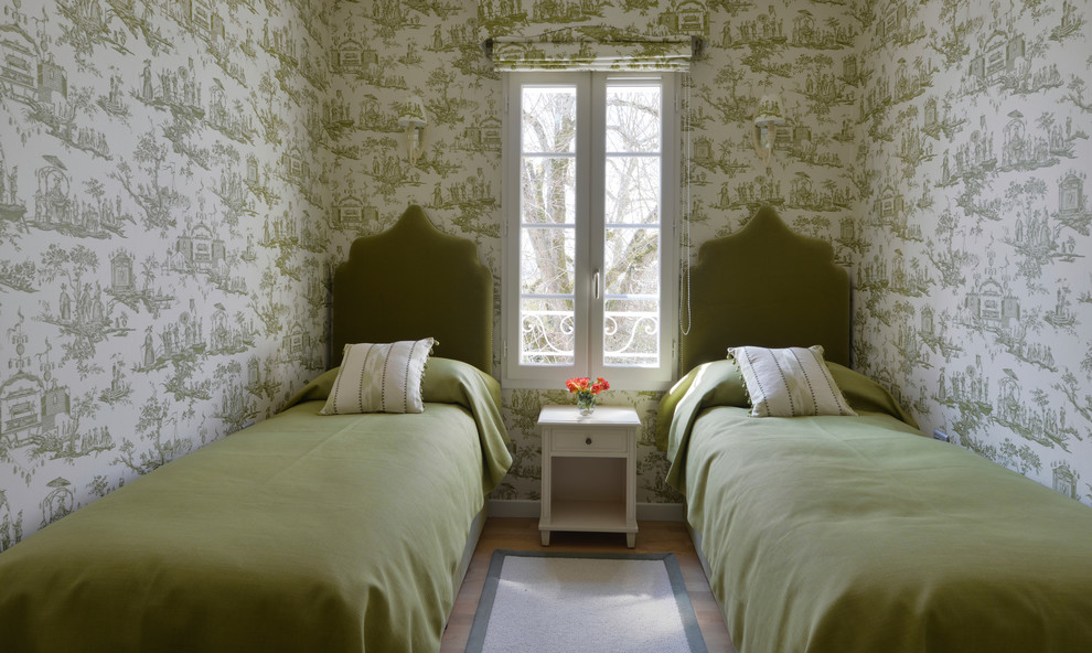 Inspiration for a traditional guest bedroom in London with green walls.