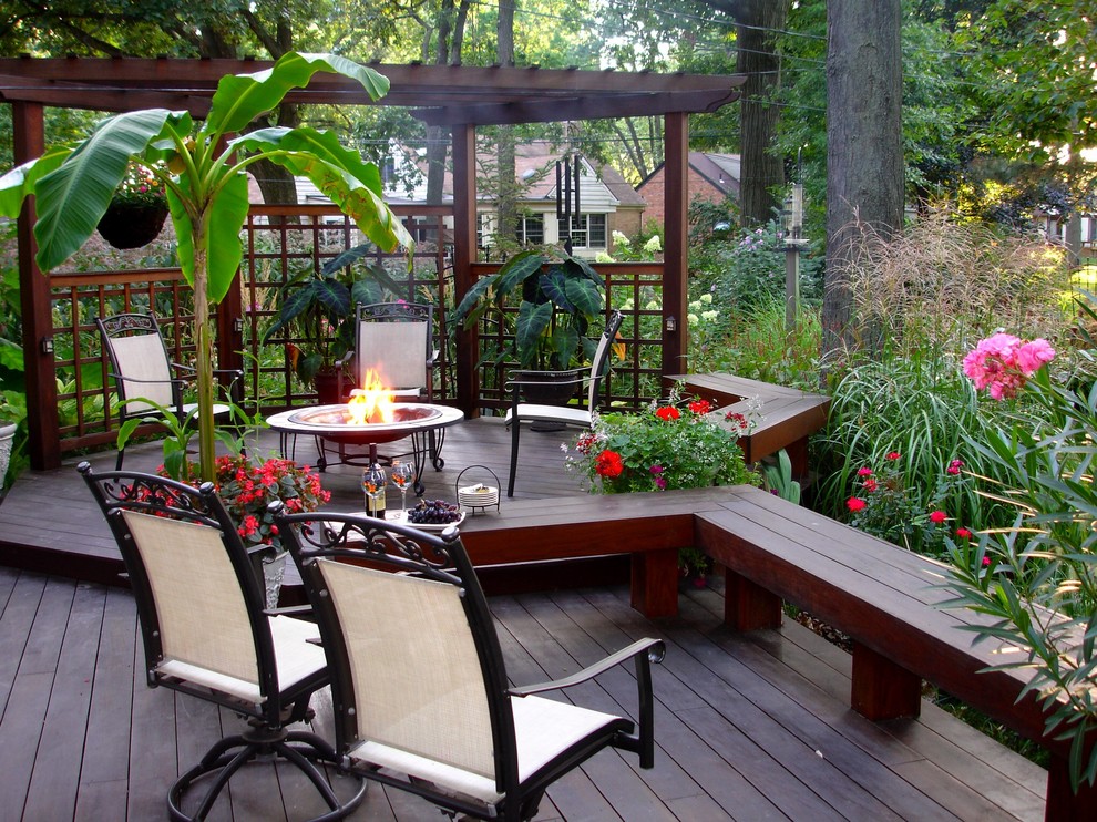 Traditional deck in Other with a fire feature and a pergola.