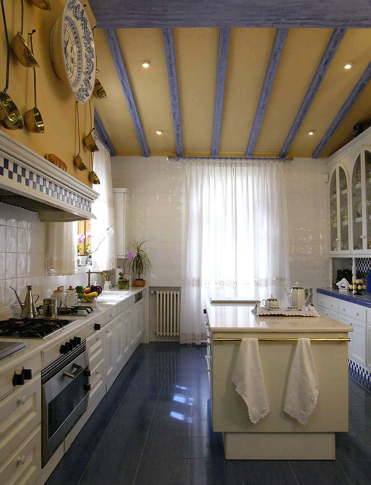 Design ideas for a traditional kitchen in Other with glass-front cabinets and blue floor.