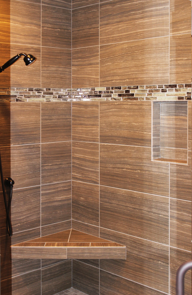 Mid-sized contemporary master bathroom in Cedar Rapids with light wood cabinets, a freestanding tub, a corner shower, porcelain floors, brown tile, ceramic tile, brown walls, beige floor and a hinged shower door.
