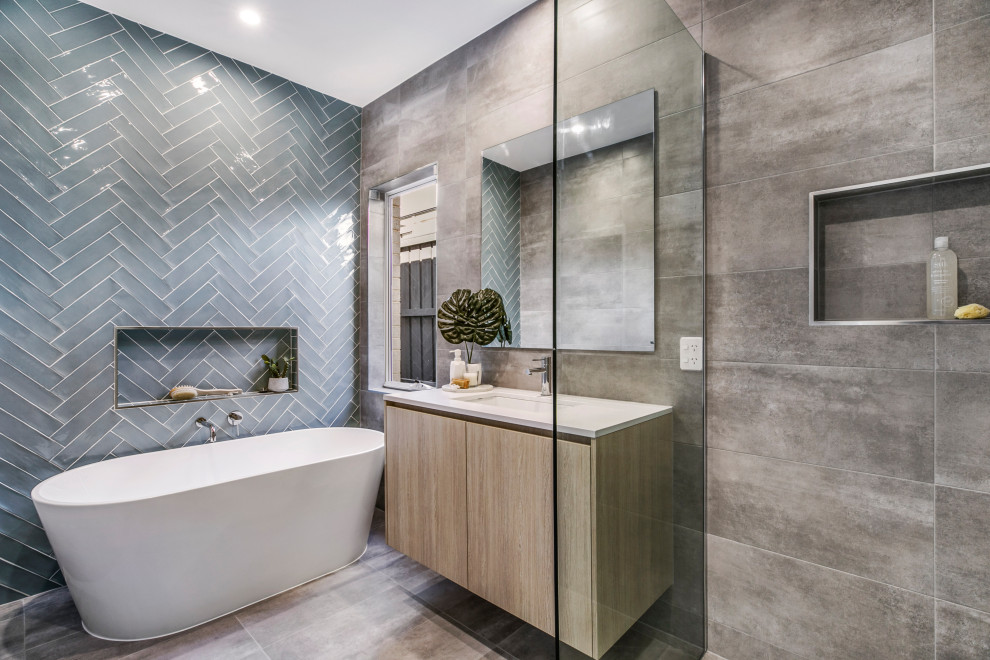 Photo of a mid-sized contemporary bathroom in Melbourne with gray tile, marble, an undermount sink, grey floor, white benchtops, an enclosed toilet, a single vanity and a built-in vanity.