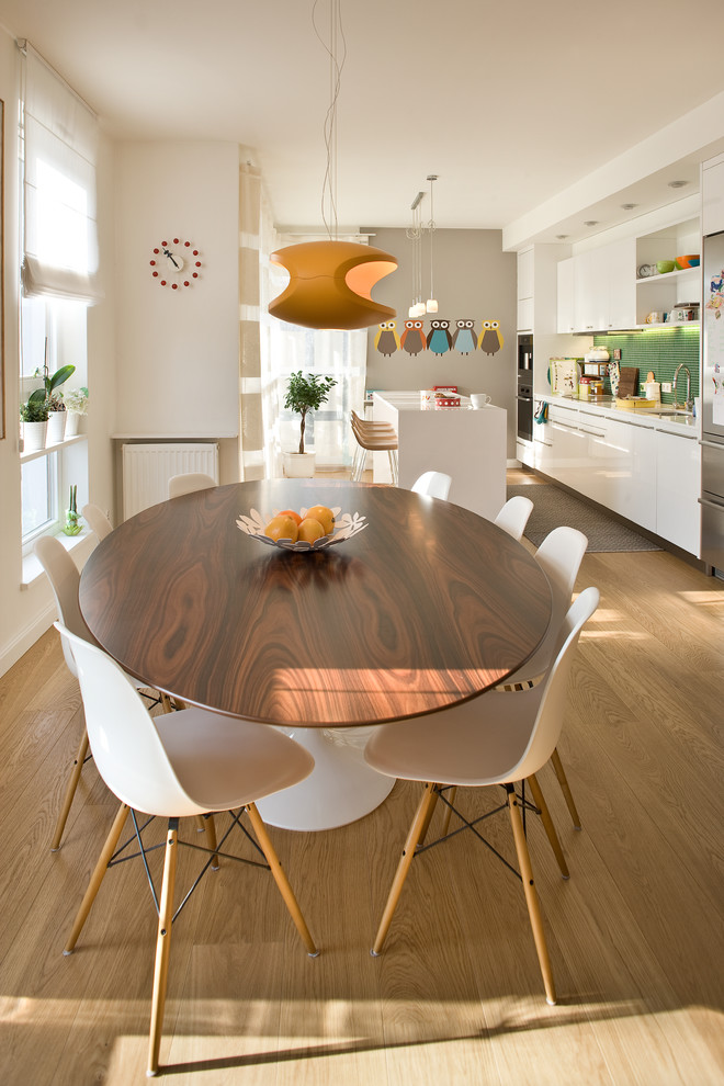Design ideas for a contemporary kitchen/dining combo in Other with white walls and light hardwood floors.