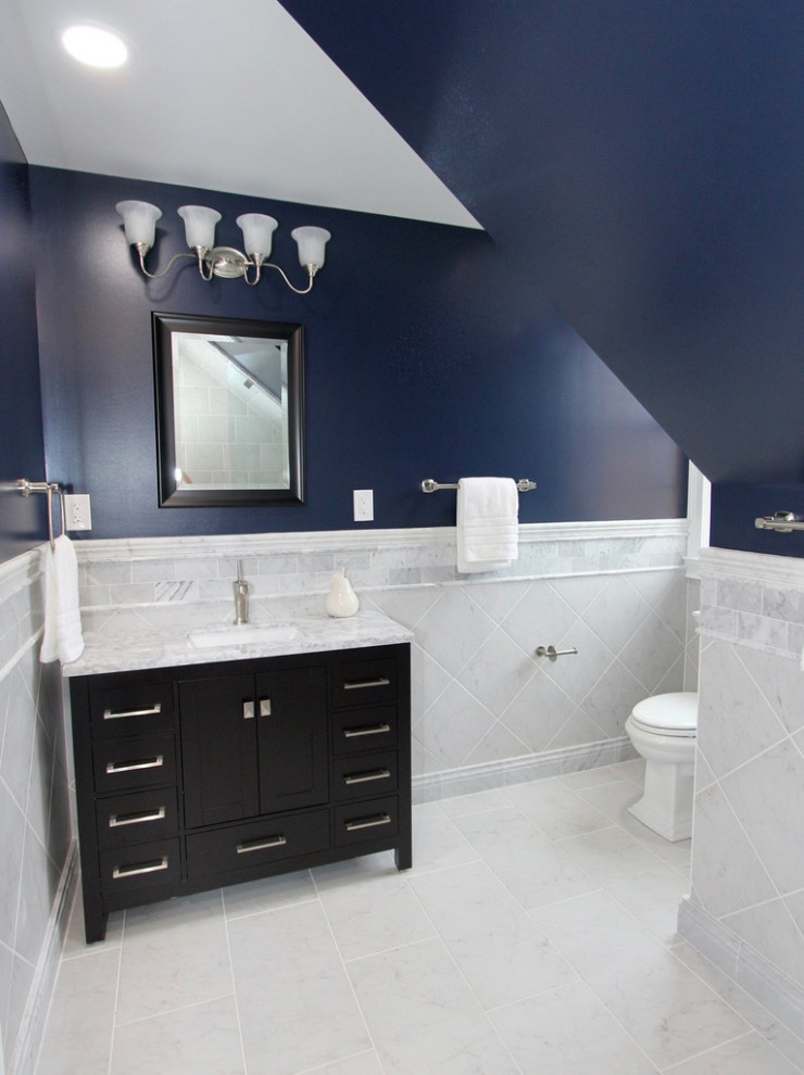 Bathroom - mid-sized traditional white tile and ceramic tile ceramic tile, white floor and single-sink bathroom idea in Baltimore with shaker cabinets, dark wood cabinets, a two-piece toilet, blue walls, a drop-in sink, marble countertops, a hinged shower door, white countertops and a freestanding vanity