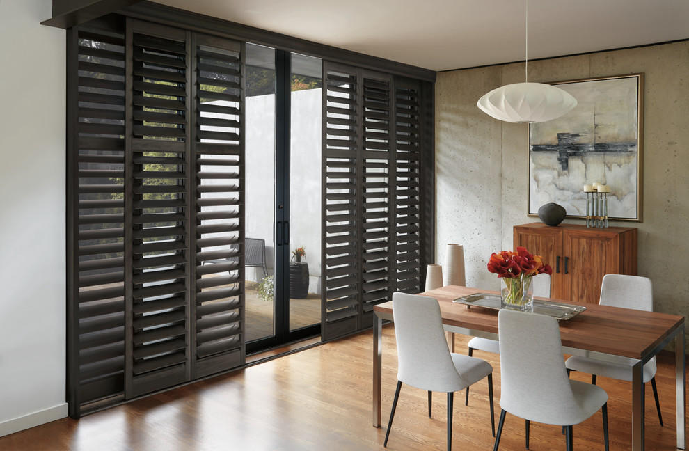 Enclosed dining room - large transitional medium tone wood floor and brown floor enclosed dining room idea with gray walls and no fireplace