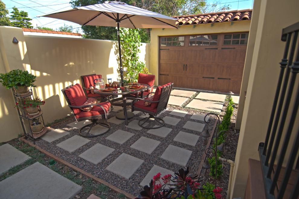 Photo of a mid-sized mediterranean backyard patio in Los Angeles with concrete pavers, a pergola and a container garden.