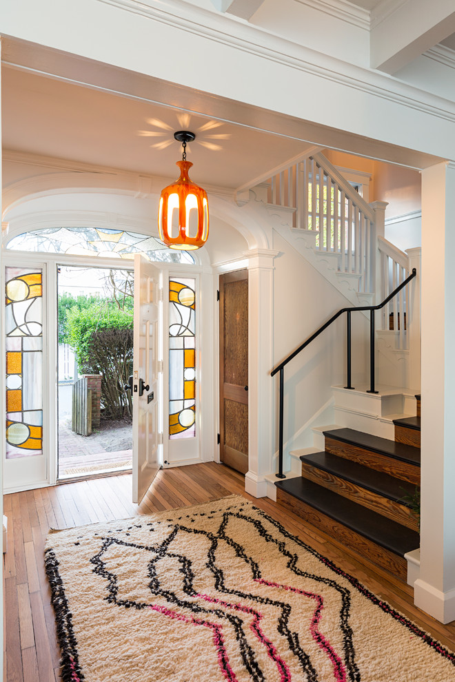 Photo of a traditional foyer in Boston with white walls, medium hardwood floors, a single front door and a white front door.