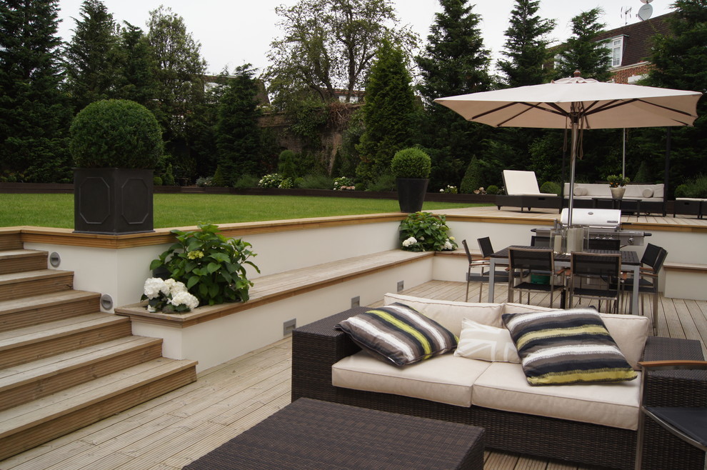Large traditional backyard deck in London.
