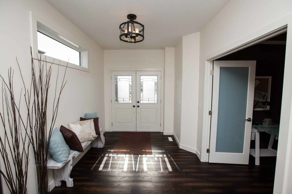 Mid-sized country foyer in Edmonton with white walls, dark hardwood floors, a double front door and a white front door.