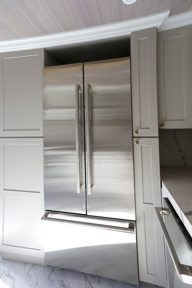 Example of a mid-sized transitional l-shaped marble floor, white floor and exposed beam kitchen design in DC Metro with an undermount sink, shaker cabinets, white cabinets, quartzite countertops, white backsplash, quartz backsplash and stainless steel appliances