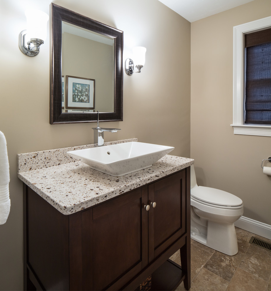 Design ideas for a small transitional powder room in Boston with medium wood cabinets, a one-piece toilet, a vessel sink, beige walls, shaker cabinets, brown tile, porcelain floors and engineered quartz benchtops.