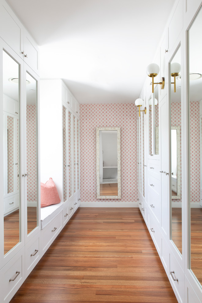 Photo of a large beach style entryway in Gold Coast - Tweed with pink walls, medium hardwood floors and brown floor.